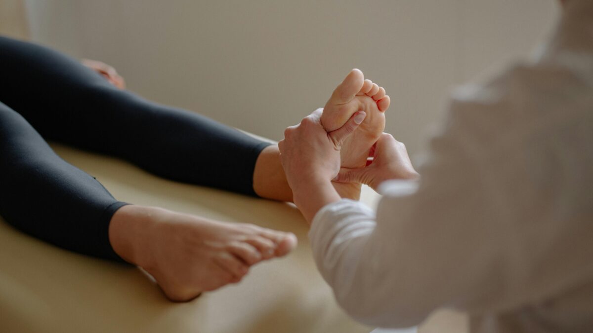 Podólogo y fisioterapeuta en Las Águilas Aluche tratando pie de paciente con dedos en garra